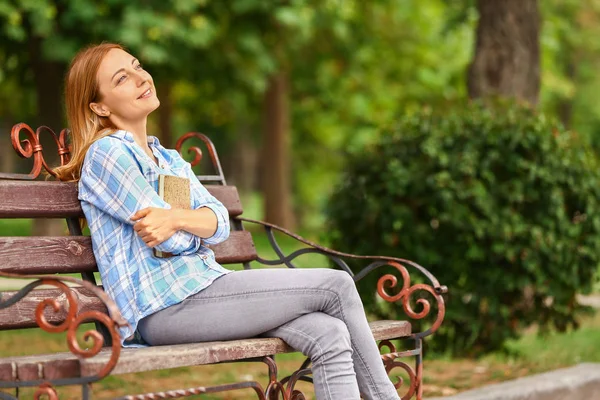 Woman relaxing on bench in park — Stock Photo, Image