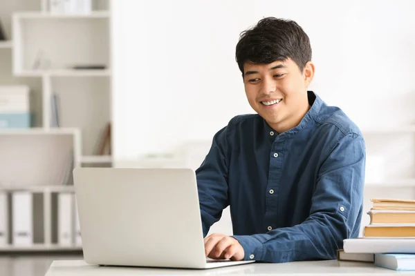 Asian student with laptop preparing for exam at home — Stock Photo, Image