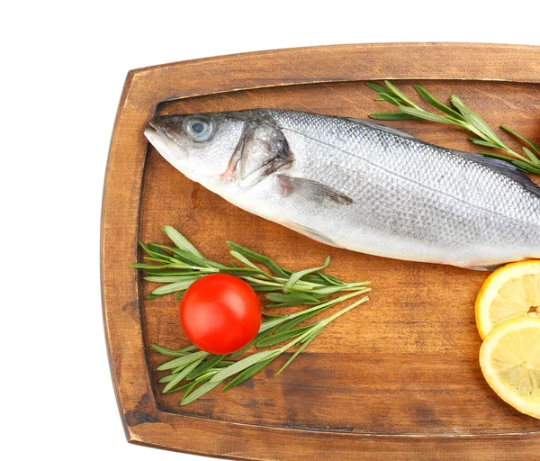 Board with fresh seabass fish, lemon, rosemary and tomato on white background — Stock Photo, Image