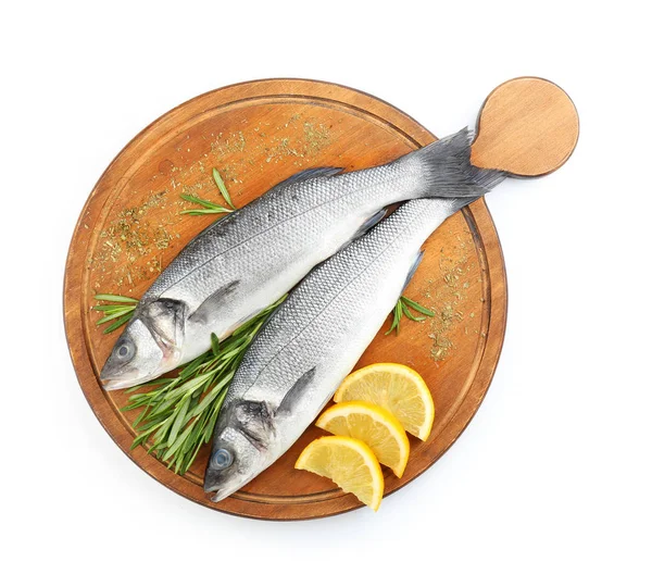 Board with fresh seabass fish, rosemary and lemon on white background — Stock Photo, Image