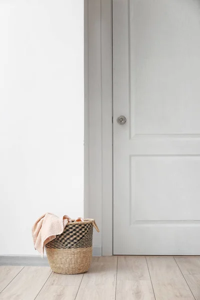 Basket with laundry on floor in room — Stock Photo, Image