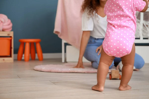 Cute little baby learning to walk at home — Stock Photo, Image