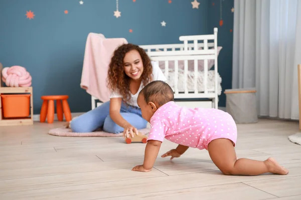 Cute African-American baby with mother at home — Stock Photo, Image