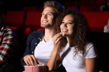 Patlamış mısırlı çift sinemada film izliyor.