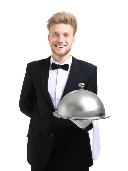 Bellissimo cameriere con vassoio e cloche su sfondo bianco — Foto Stock