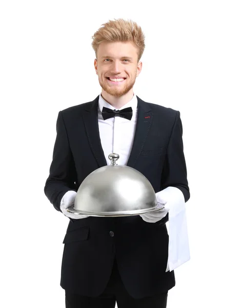 Bellissimo cameriere con vassoio e cloche su sfondo bianco — Foto Stock