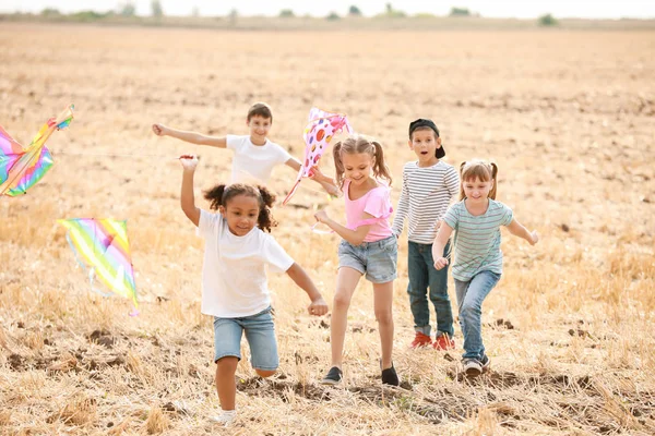 Little children flying kites outdoors — Stock Photo, Image