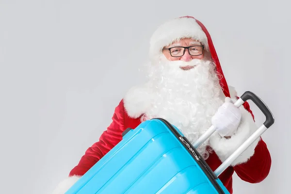 Santa Claus with luggage on white background — Stock Photo, Image