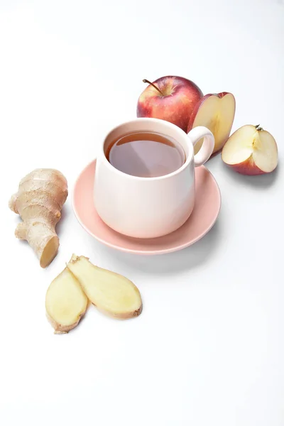 Cup of hot tea with apple and ginger on white background — Stock Photo, Image