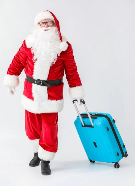 Santa Claus with luggage on white background — Stock Photo, Image