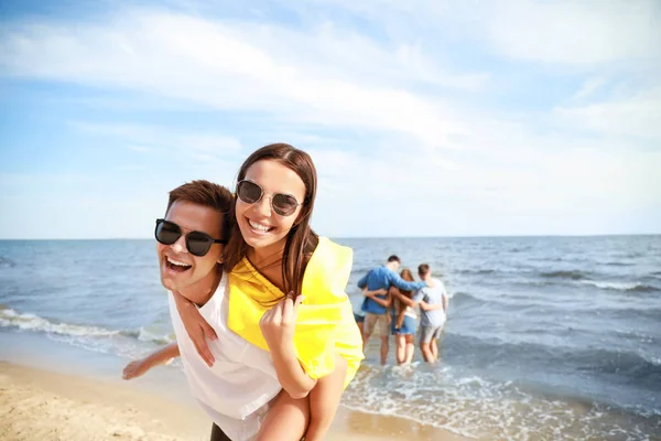 Amigos felizes na praia do mar no resort — Fotografia de Stock