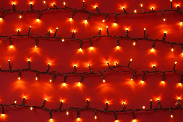 Gyönyörű karácsonyi fények a színes háttér — Stock Fotó