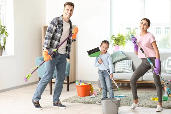 Happy family cleaning flat together