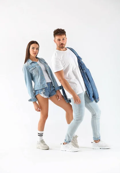 Fashionable young couple on white background — Stock Photo, Image