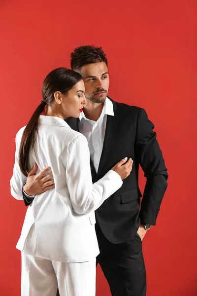 Stylish young couple on color background — Stock Photo, Image