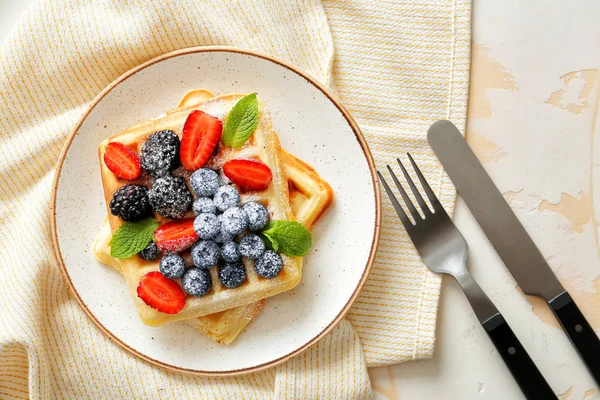 Plate with tasty waffles and berries on table — Stock Photo, Image