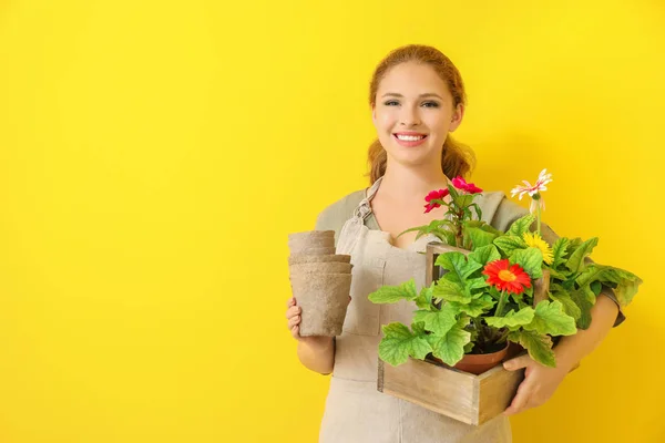 Portrait of female gardener on color background — Stock Photo, Image