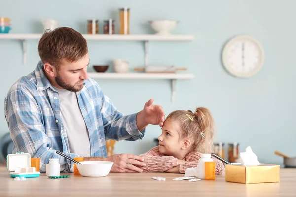 Father taking care of his sick daughter at home — Stock Photo, Image