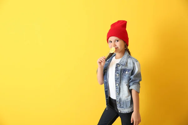 Portrait of cute girl with lollipop on color background — Stock Photo, Image