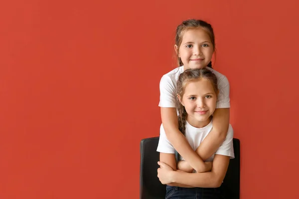 Portrait of cute twin girls on color background — Stock Photo, Image