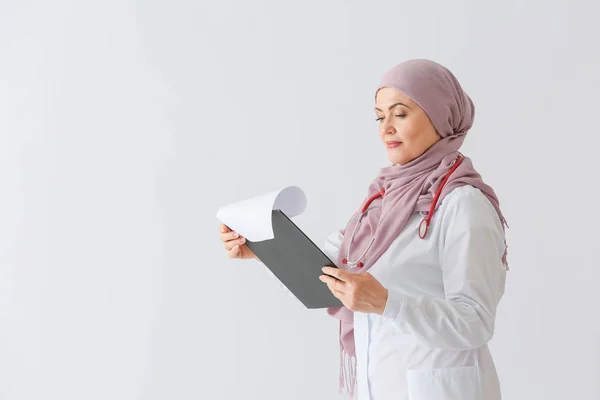 Beautiful mature Muslim doctor on light background — Stock Photo, Image