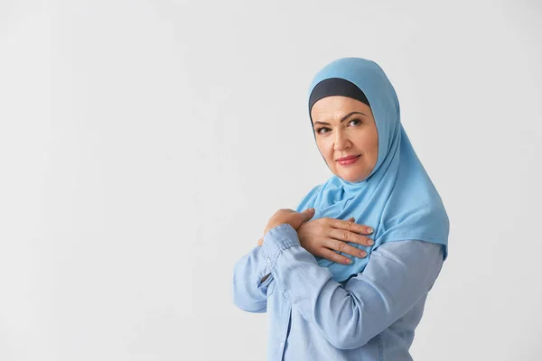 Mooie rijpe moslim vrouw op lichte achtergrond — Stockfoto
