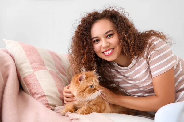 Joven mujer afroamericana con lindo gato en casa — Foto de Stock