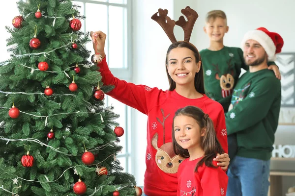 Happy family decorating Christmas tree at home — Stock Photo, Image