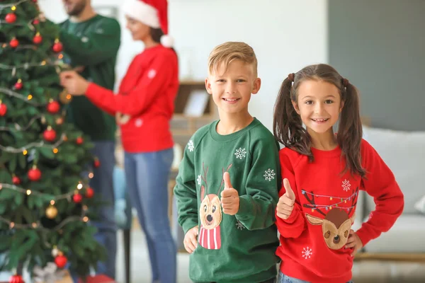 Happy children showing thumb-up at home on Christmas eve — Stock Photo, Image
