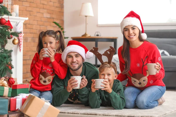 Happy family drinking hot chocolate at home on Christmas eve — Stock Photo, Image