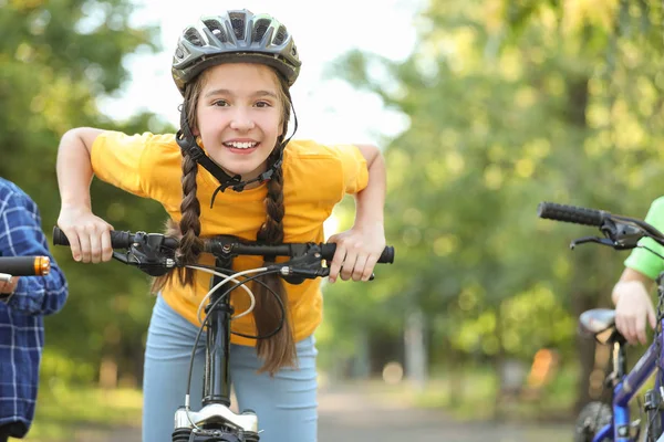 Cute children riding bicycles outdoors — Stock Photo, Image