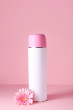 Bottle of air freshener on color background clipart
