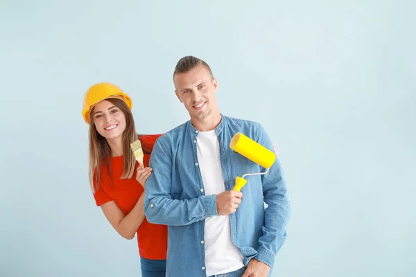 Happy young couple doing repair in their new house — Stock Photo, Image