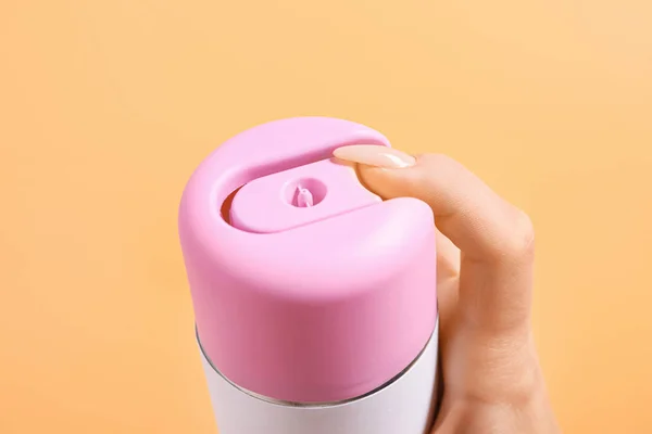 Female hand with bottle of air freshener on color background, closeup — Stock Photo, Image