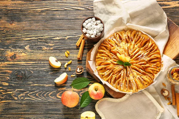 Composition with sweet apple pie on wooden table