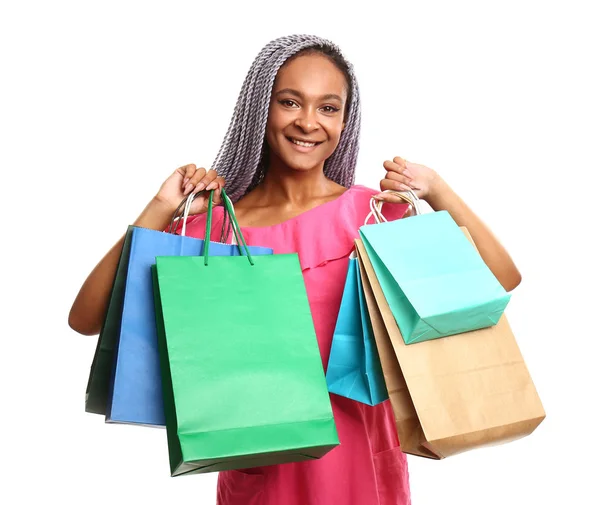 Happy African-American woman with shopping bags on white background — Stock Photo, Image