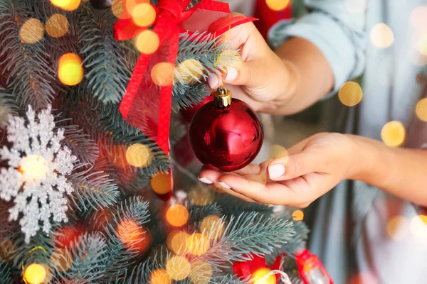 Woman decorating beautiful Christmas tree at home, closeup — Stock Photo, Image