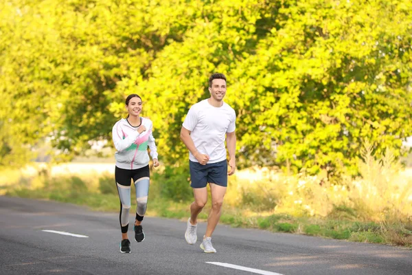 Sporty young couple running outdoors