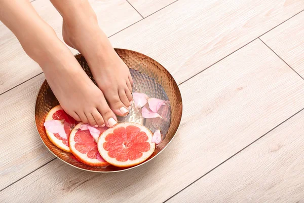 Young woman undergoing spa pedicure treatment in beauty salon