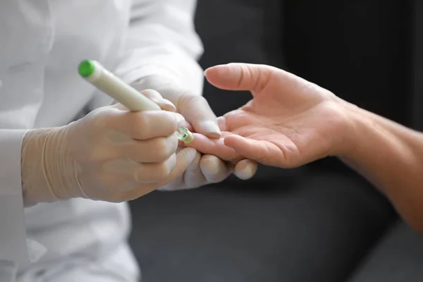 Doctor taking blood sample of diabetic woman at home, closeup — Stock Photo, Image