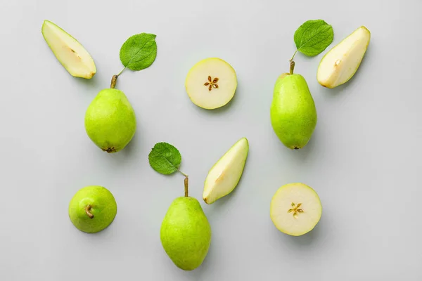 Välsmakande färska päron med löv på grå bakgrund — Stockfoto