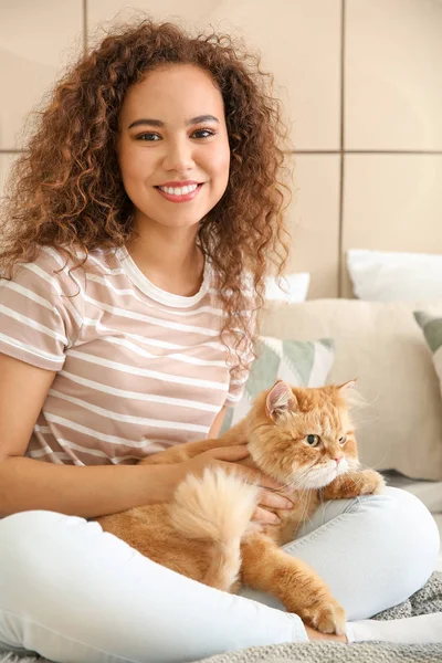 Jovem afro-americana com gato bonito em casa — Fotografia de Stock