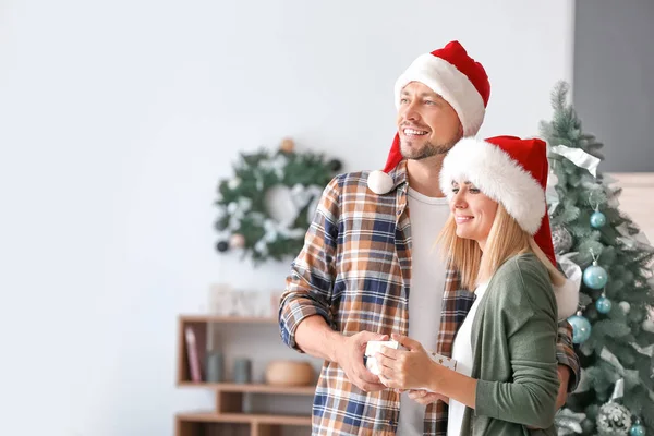 Happy couple with Christmas gift at home — Stock Photo, Image