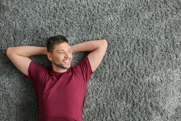 Happy man lying on floor, top view — Stock Photo, Image
