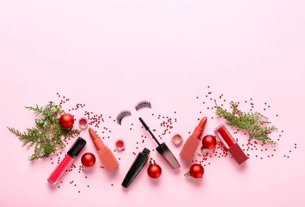 Set of cosmetics with Christmas decor on color background — Stock Photo, Image