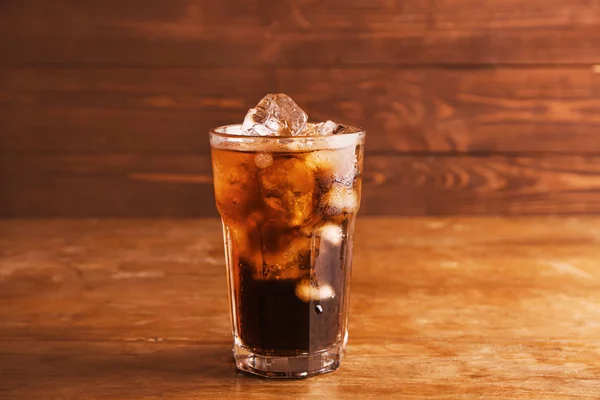 Glass of cold cola on wooden background — Stock Photo, Image