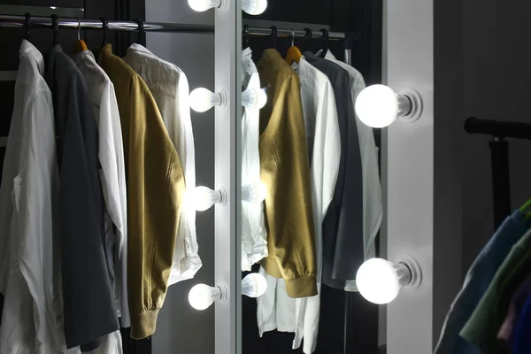 Stojak z ubraniami i stylowym lustrem w nowoczesnej garderobie — Zdjęcie stockowe