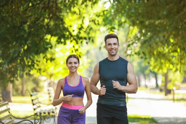 Deportiva joven pareja corriendo en parque — Foto de Stock