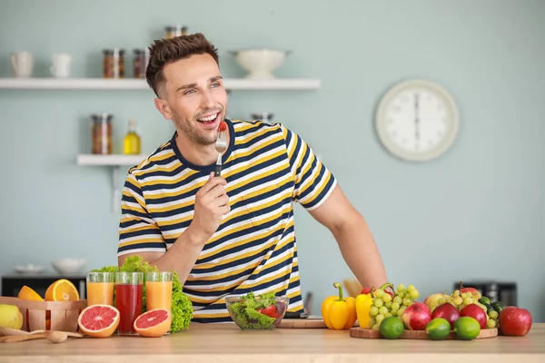 Handsome man with healthy food in kitchen. Weight loss concept — Stock Photo, Image