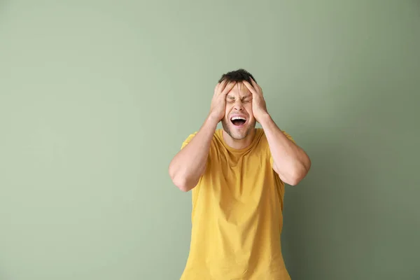 Portrait of stressed man on color background — Stock Photo, Image